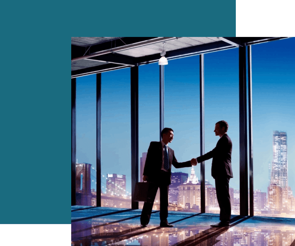 Two men shaking hands in front of a window.